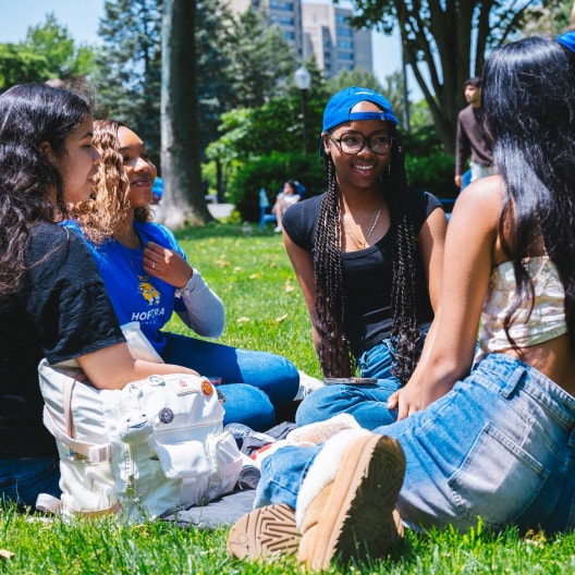 students relaxing on campus, talking together